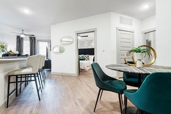 a living area with white walls and hardwood floors